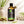 Load image into Gallery viewer, Citronella illóolaj 100 ml borostyánszínű üvegben elegáns üveg pipettával, friss citronellafű szálakkal.
