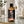 Load image into Gallery viewer, 100 ml-es grapefruit illóolaj borostyánszínű üvegben fekete kupakkal, üveglapon elhelyezve, mellette arany színű kupakos üvegpipetta.
