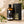 Load image into Gallery viewer, Neroli illóolaj 100 ml elegáns díszdobozban, borostyánszínű üvegben, fehér narancsvirágokkal díszített, világos természetes háttér előtt.
