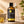 Load image into Gallery viewer, Szalmagyopár (Helichrysum) illóolaj 100 ml barna üvegben arany részletekkel, mellette álló üveg pipettával.
