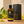 Load image into Gallery viewer, 100 ml-es ylang ylang illóolaj borostyánszínű üvegben fekete prémium díszdoboz mellett, világos fa felületen.
